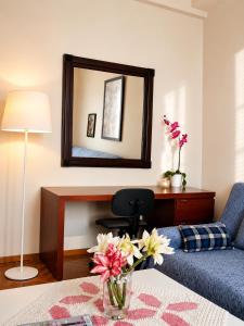 a living room with a vase of flowers on a table at Alexandra's house in Arta