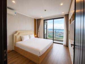 a bedroom with a bed and a large window at V Hạ Long in Ha Long +4 photos
