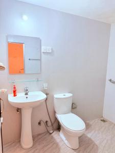 a bathroom with a white toilet and a sink at Thalpe Gedara Villa in Talpe