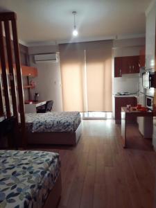 a hotel room with two beds and a kitchen at yurt odası in Troulli