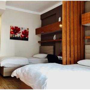 a bedroom with two beds and a desk at yurt odası in Troulli