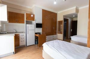 a kitchen with a large white bed in a room at yurt odası in Troulli