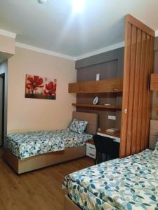 a hotel room with two beds and a desk at yurt odası in Troulli