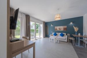 a living room with a couch and a table at Comfort Aparthotel Cannes Mandelieu in Mandelieu-La Napoule