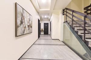 a hallway with stairs and a painting on the wall at FabHotel Harsh Paradise - Malviya Nagar in Jaipur +31 photos