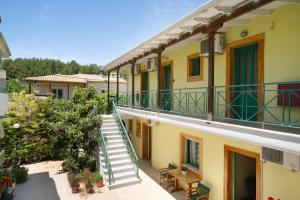 an apartment building with stairs and a balcony at Lenia Studios in Kalamitsi