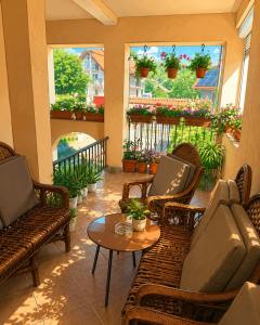 a patio with chairs and a table and some plants at Apartmani VV in Cetinje