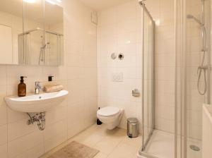a bathroom with a sink and a toilet and a shower at MOWO Kornwestheim in Kornwestheim