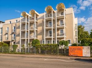 an apartment building with gold domes on its balconies at MOWO Kornwestheim in Kornwestheim