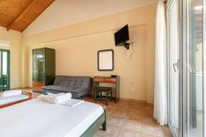 a living room with two beds and a couch at Lenia Studios in Kalamitsi