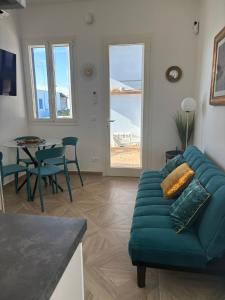 a living room with a green couch and a table at Essenza di Mare Luxury B&B in Torre dell'Orso