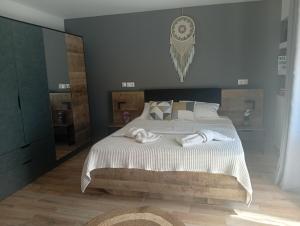 a bedroom with a large bed with towels on it at Spartines home in Votsi