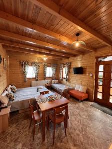 a living room with a bed and a couch at Petőfi 35 Vendégház in Sirok