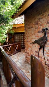 a statue of a bird on the side of a brick wall at Aark Guest Lodge in Vanderbijlpark