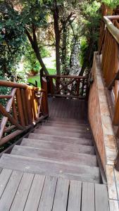 a wooden walkway with a wooden fence and trees at Aark Guest Lodge in Vanderbijlpark
