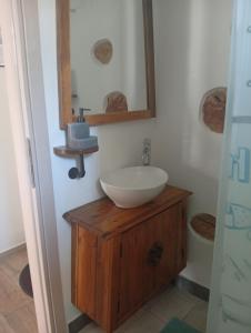 a bathroom with a white sink and a mirror at Spartines home in Votsi +32 photos