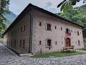 a stone building with a table in front of it at Rifugio Forte di Machaby in Arnad +34 photos
