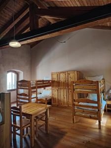 a room with wooden furniture and a table and chairs at Rifugio Forte di Machaby in Arnad
