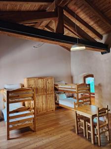 a room with two bunk beds and a table and chairs at Rifugio Forte di Machaby in Arnad