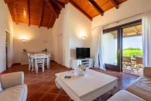 a living room with a couch and a table at Villa Glory piscina privata in Cuile Pazzoni