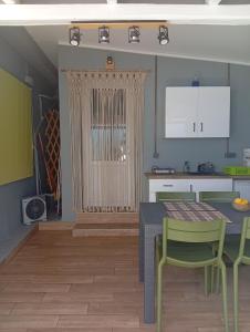 a kitchen with a table and chairs and a dining room at Spartines home in Votsi