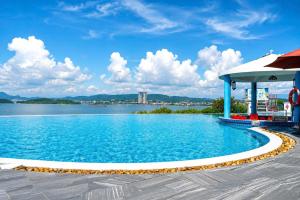 a swimming pool with a gazebo next to a lake at V Hạ Long in Ha Long