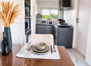 a kitchen with a wooden table with a bowl on it at Gracious Haven - Fully Equipped Rooftop with private terrace house in Saint-Pierre, Moka in Moka