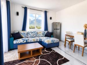 a living room with a couch and a table at Gracious Haven - Fully Equipped Rooftop with private terrace house in Saint-Pierre, Moka in Moka