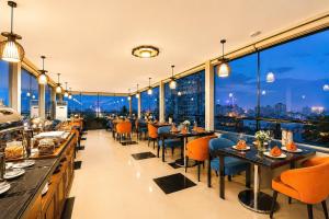 a restaurant with tables and chairs and a view of the city at Parkside Sunline Hotel in Hanoi +72 photos