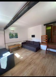 a living room with a couch and a table at Camp Rooms in Jajce