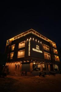 a building with lights on top of it at night at Hotel Sharma Jaipur in Jaipur