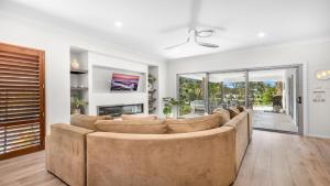 a living room with a couch and a fireplace at Alkira at The Vintage in Pokolbin
