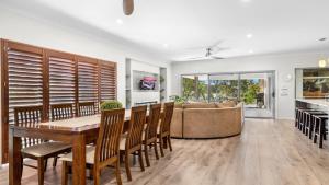 a kitchen and dining room with a table and a couch at Alkira at The Vintage in Pokolbin