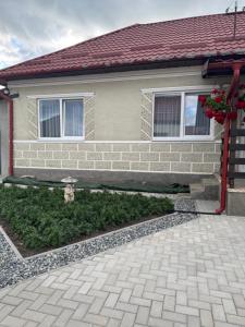 a house with a stone driveway in front of it at Luci's House in Jucu de Mijloc +12 photos