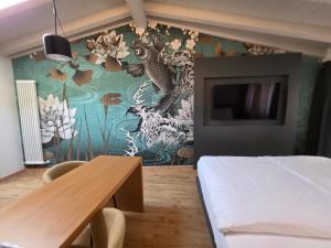 a bedroom with a bed and a wall mural at M Loft - adults only in Malcesine