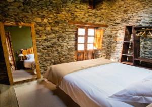 a bedroom with a large bed and a mirror at Casa Rural Mariola in Ordino