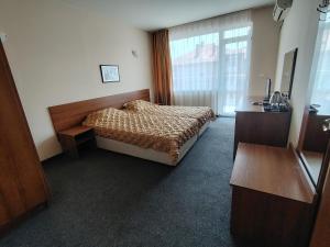 a bedroom with a bed and a large window at Sandor Hotel in Nesebar +76 photos