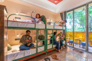 a group of people sitting in bunk beds in a room at Zostel Kolkata in Kolkata +50 photos