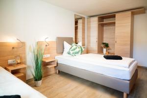 a bedroom with a large white bed and wooden walls at Monteurzimmer in Nordhausen