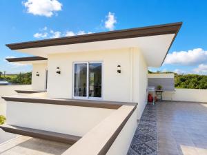 a white house with a window on a roof at Gracious Haven - Fully Equipped Rooftop with private terrace house in Saint-Pierre, Moka in Moka