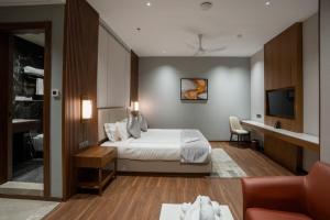a hotel room with a bed and a television at Park Central Hotel in Ahmadnagar