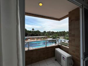 a balcony with a view of a swimming pool at Gran Lençóis Flat Residence - Flat 302 in Barreirinhas