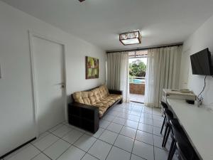 a living room with a couch and a table at Gran Lençóis Flat Residence - Flat 302 in Barreirinhas