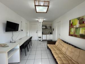 a living room with a couch and a table at Gran Lençóis Flat Residence - Flat 302 in Barreirinhas