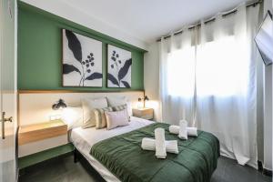 a bedroom with a large bed with two crosses on it at UP Hotel Velilla in Velilla de San Antonio
