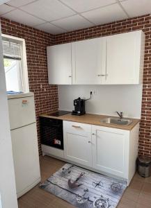 a kitchen with white cabinets and a sink at Romance in Pomorie