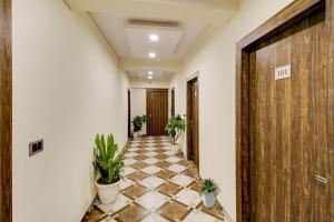 a hallway with potted plants in a building at Hotel O Times Square in Indraprast