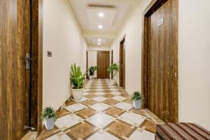 a corridor with potted plants in a building at Hotel O Times Square in Indraprast