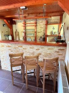a kitchen with two wooden chairs and a table at Vila Bělá pod Pradědem in Bělá pod Pradědem