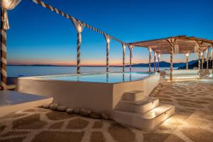 a swimming pool in a building with the ocean in the background at Silia Dream View in Houlakia